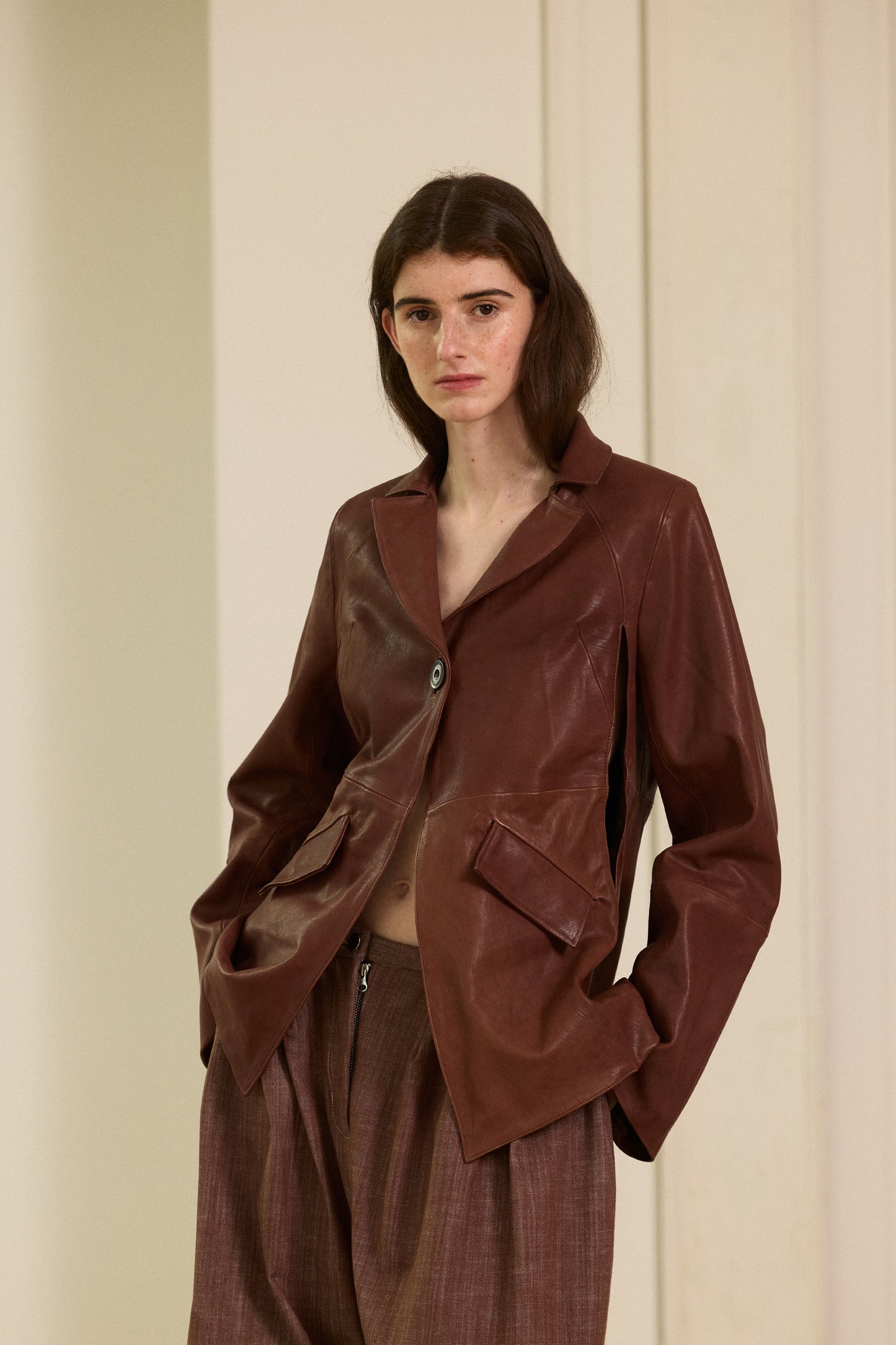 Brown leather blazer with armholes in the front