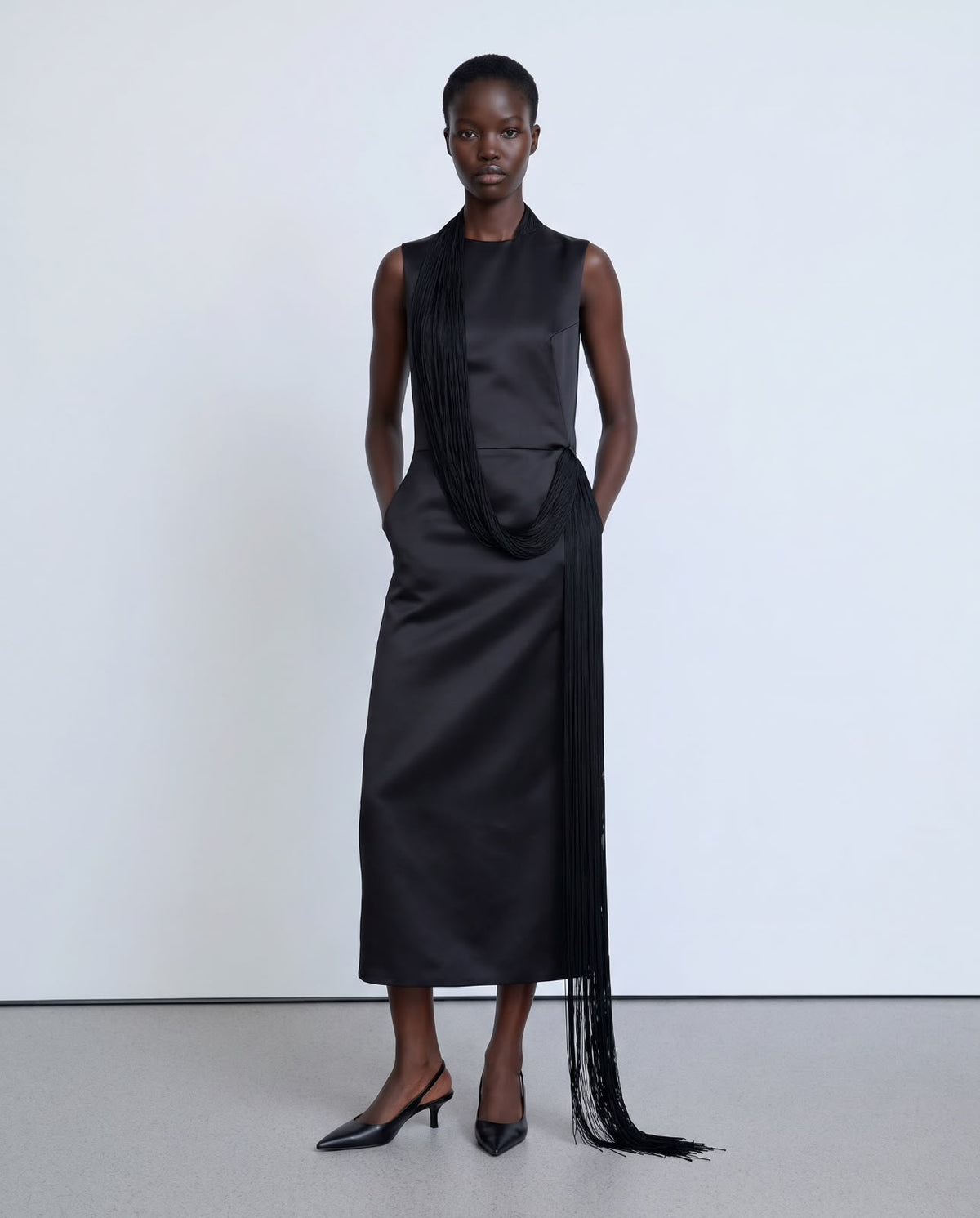 Straight-cut black dress with long fringes